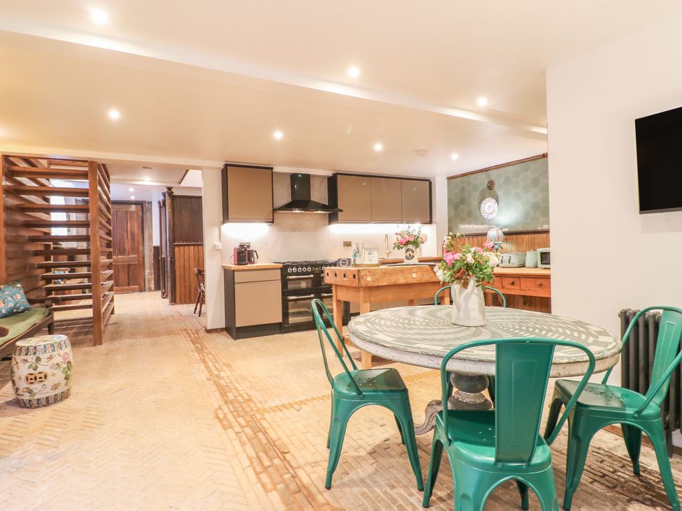 A kitchen with a dining table and chairs at Shrewsbury Lodge in Great Haywood