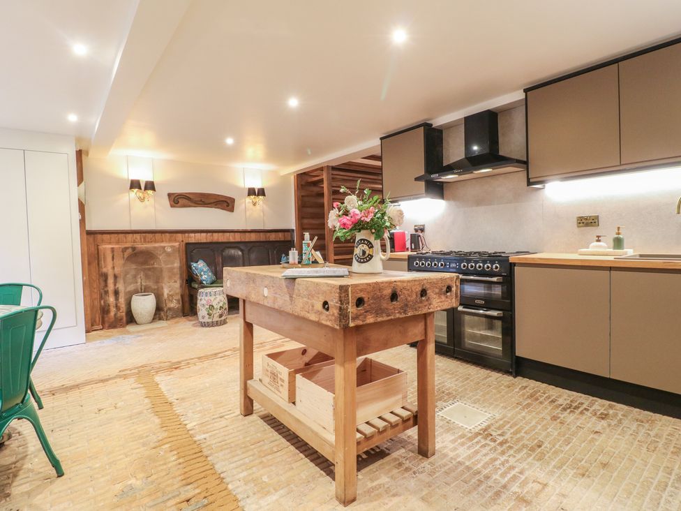 A kitchen with a central worktop and stove at Shrewsbury Lodge in Great Haywood