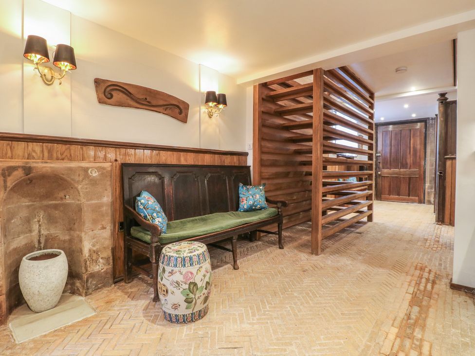 A hallway featuring a sofa and a decorative stool at Shrewsbury Lodge Great Haywood