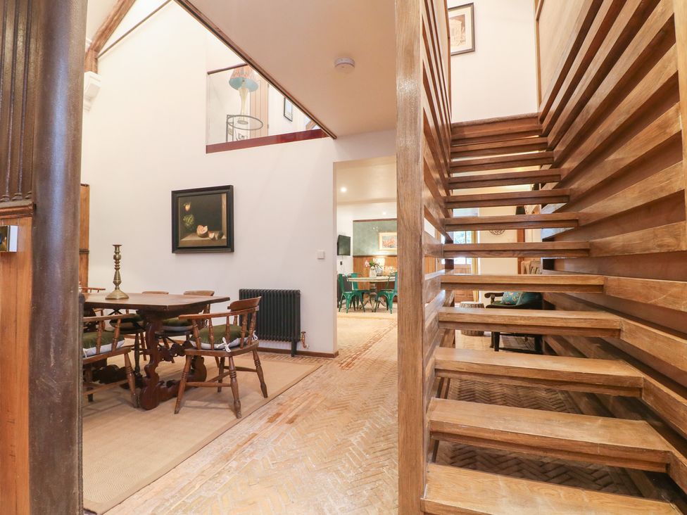 An entrance hall with staircase and dining area at Shrewsbury Lodge in Great Haywood