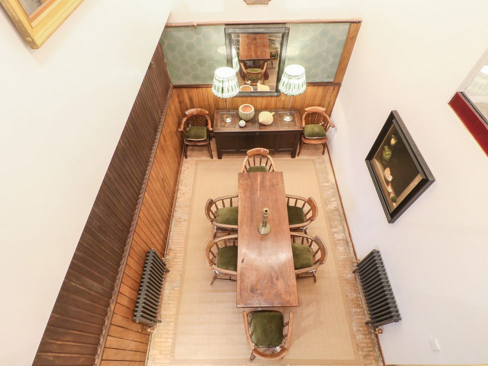 A dining room featuring a wooden table and chairs at Shrewsbury Lodge in Great Haywood
