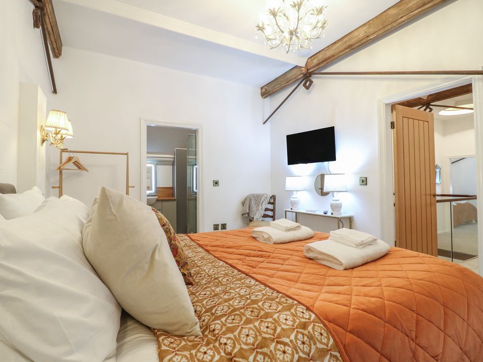 A bedroom with a bed and TV at Shrewsbury Lodge in Great Haywood