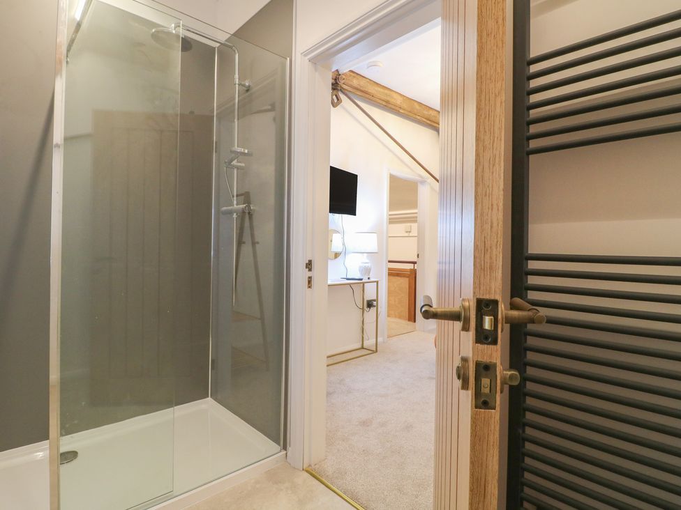 A bathroom with a shower and a towel radiator at Shrewsbury Lodge in Great Haywood