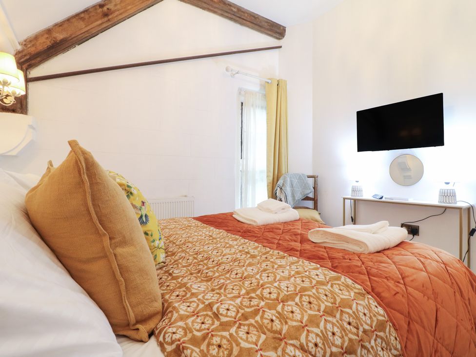 A bedroom with a bed and TV at Shrewsbury Lodge Great Haywood