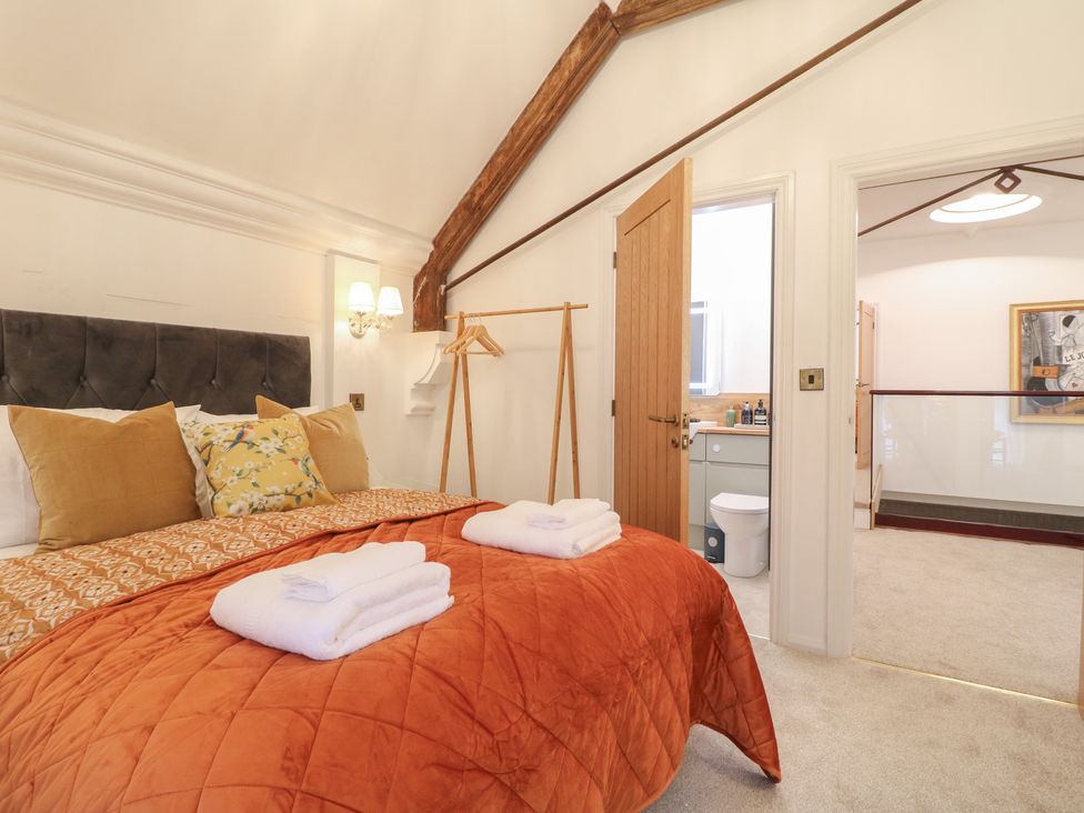 A bedroom with a bed and ensuite bathroom at Shrewsbury Lodge Great Haywood