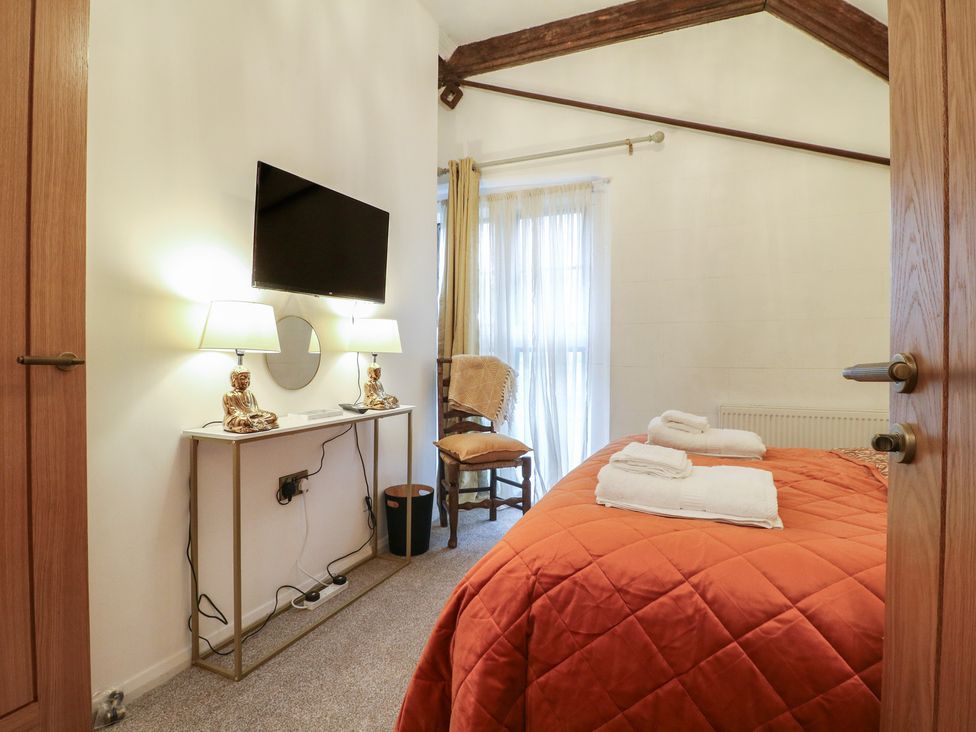 A bedroom with a bed and a TV at Shrewsbury Lodge, Great Haywood