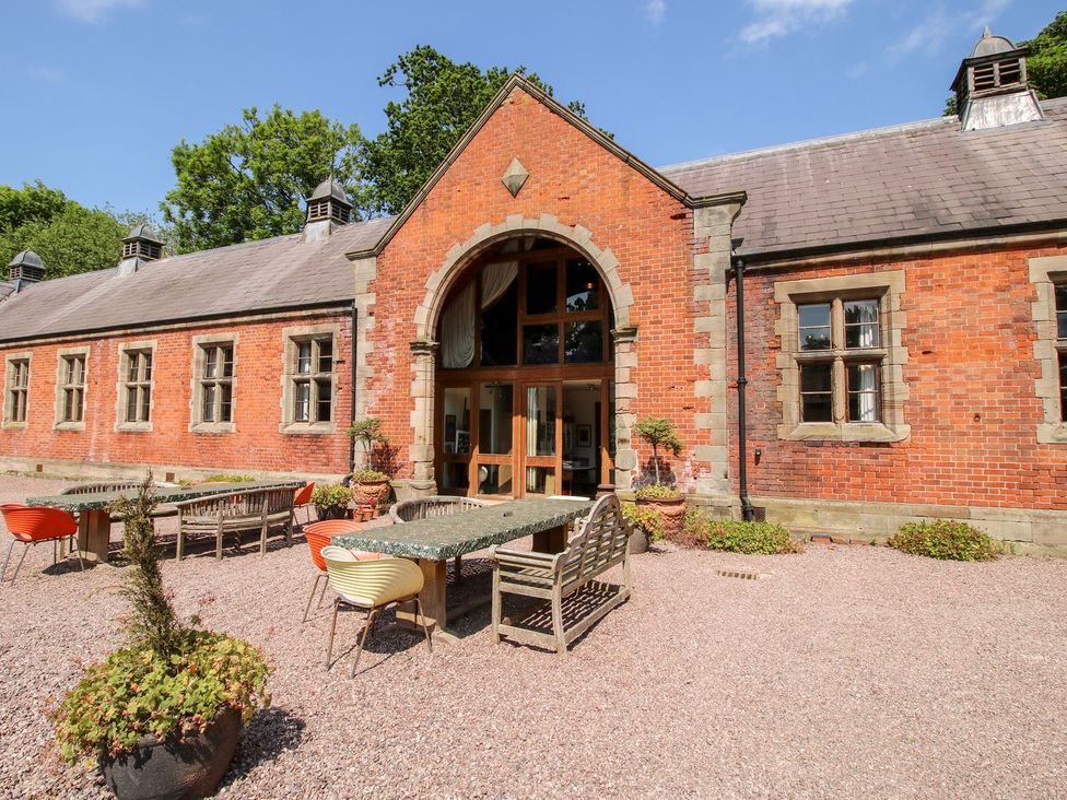 An outdoor seating area in front of a brick building at Shrewsbury Lodge Great Haywood