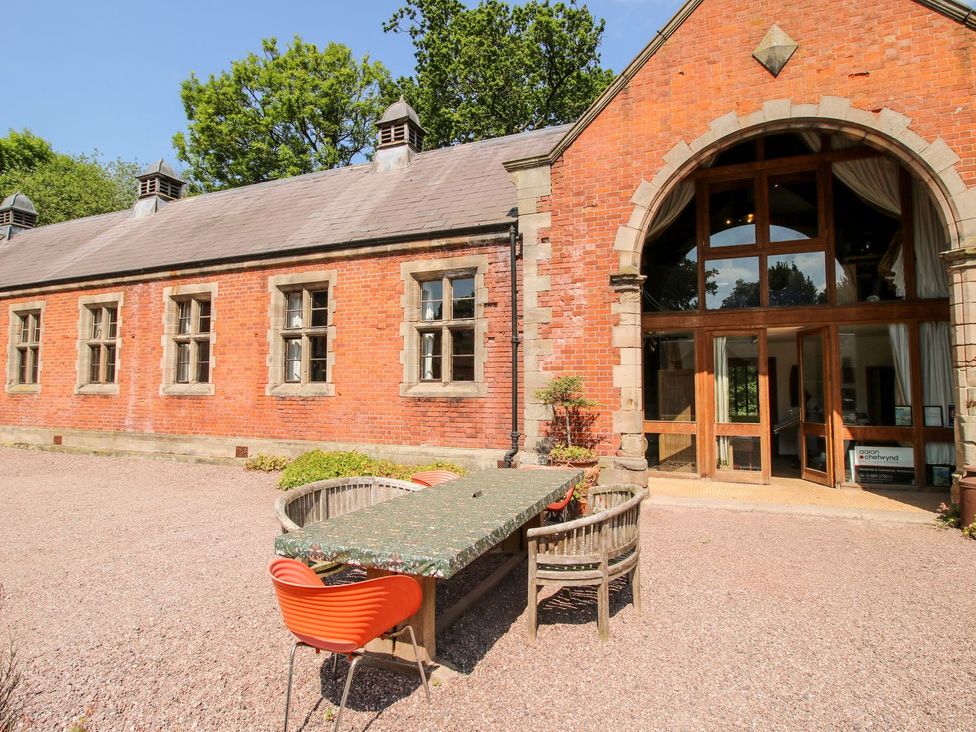 An outdoor area with a dining table and chairs at Shrewsbury Lodge Great Haywood