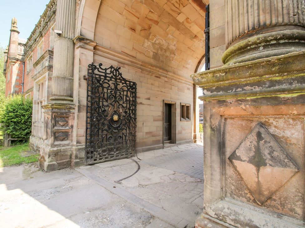 An outdoor area with a decorative gate and stone pillars at Shrewsbury Lodge Great Haywood