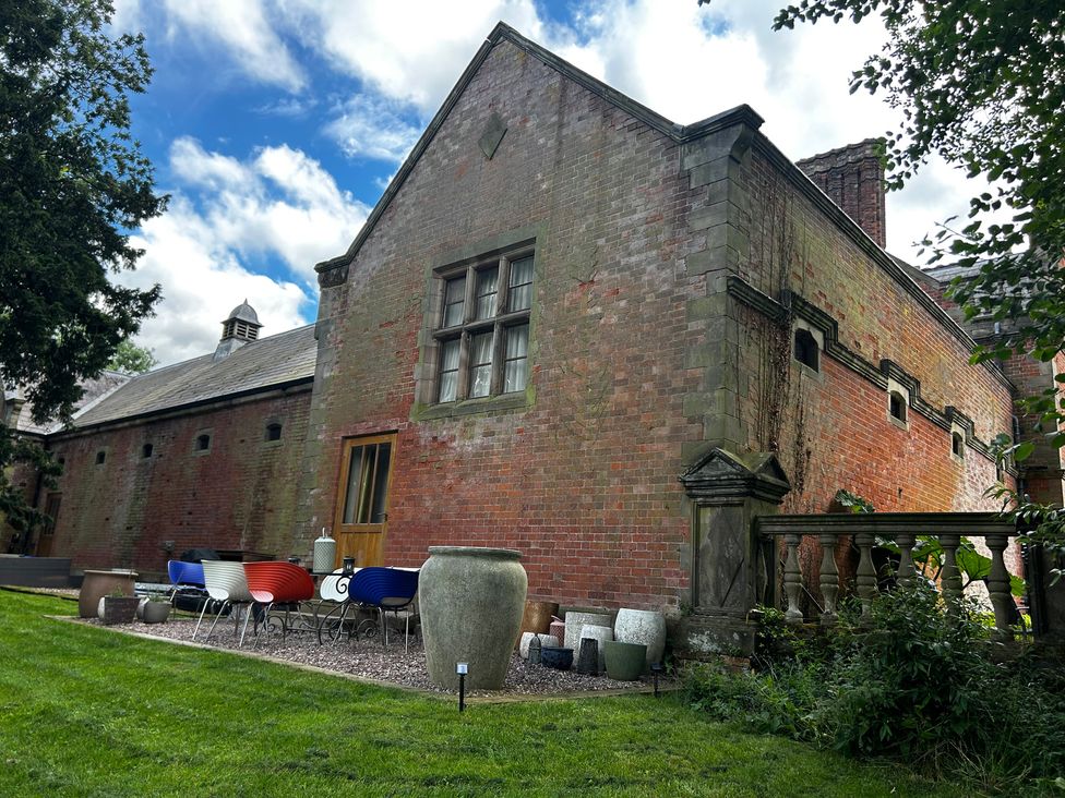 An outdoor view of a house with garden furniture at Shrewsbury Lodge Ingestre near Great Haywood