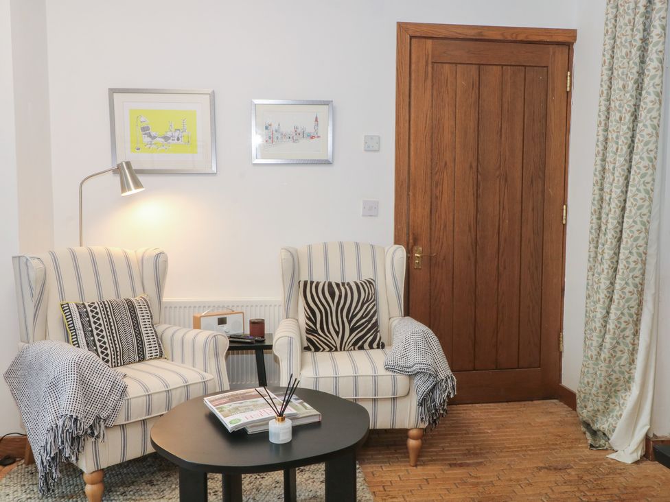 A living room with armchairs and a coffee table at Diamond Lodge in Ingestre near Great Haywood