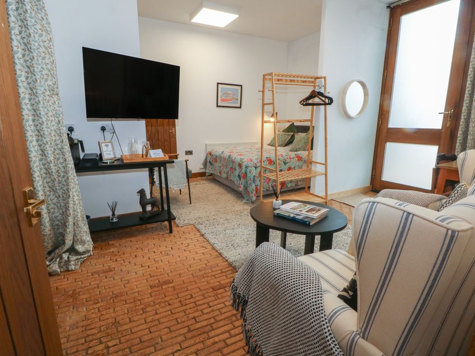 A bedroom with a bed and television at Diamond Lodge in Ingestre near Great Haywood