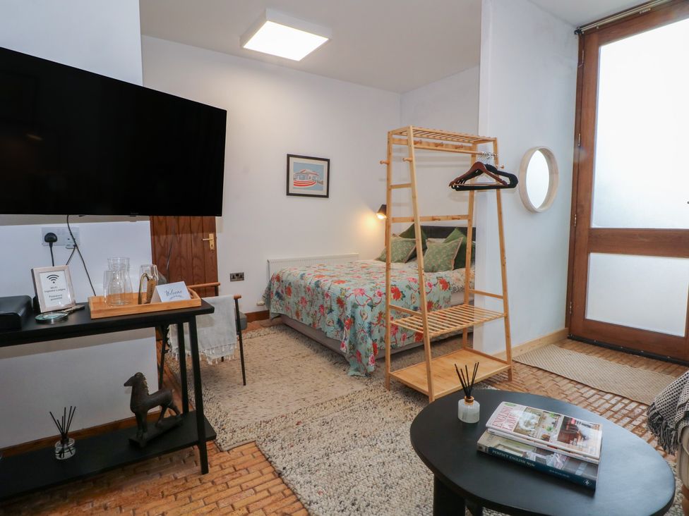 A bedroom with a bed and television at Diamond Lodge Ingestre near Great Haywood