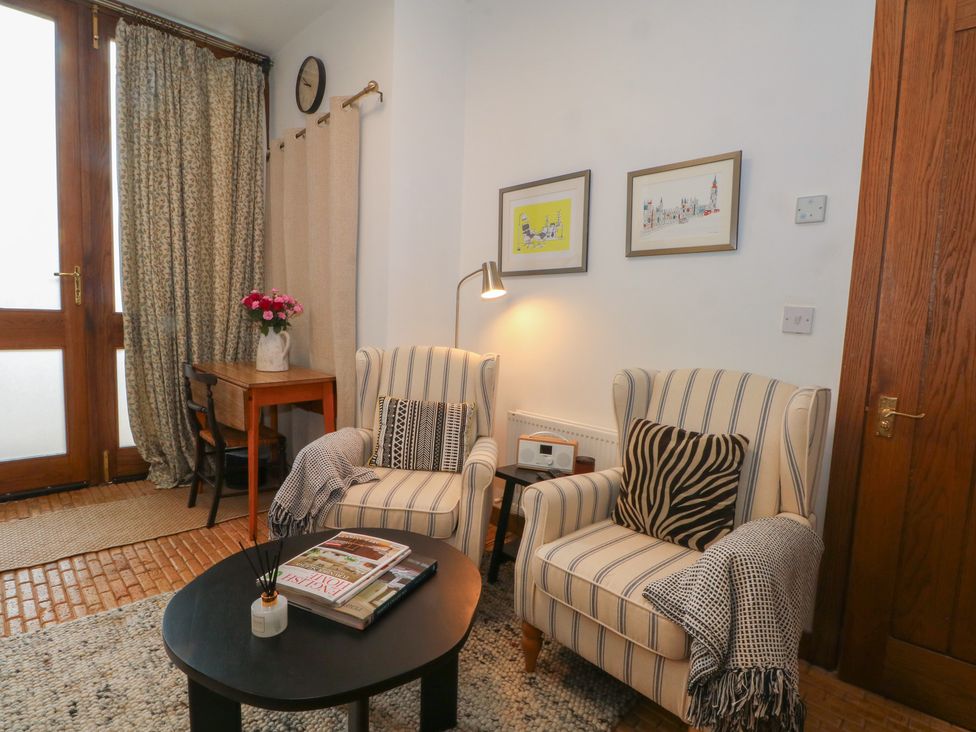 A living room with two armchairs and a table at Diamond Lodge Ingestre near Great Haywood