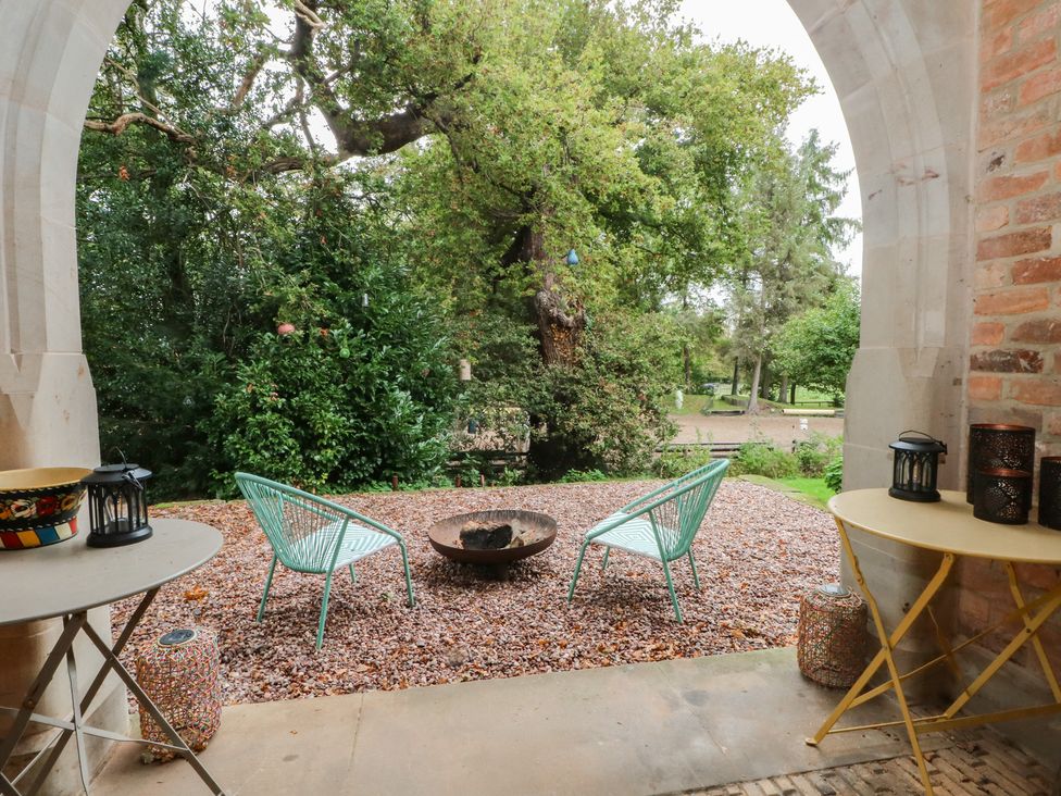 A patio area with chairs and a fire pit at Diamond Lodge Ingestre near Great Haywood