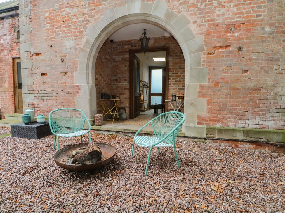 An outdoor area with seating and a fire pit at Diamond Lodge Ingestre near Great Haywood