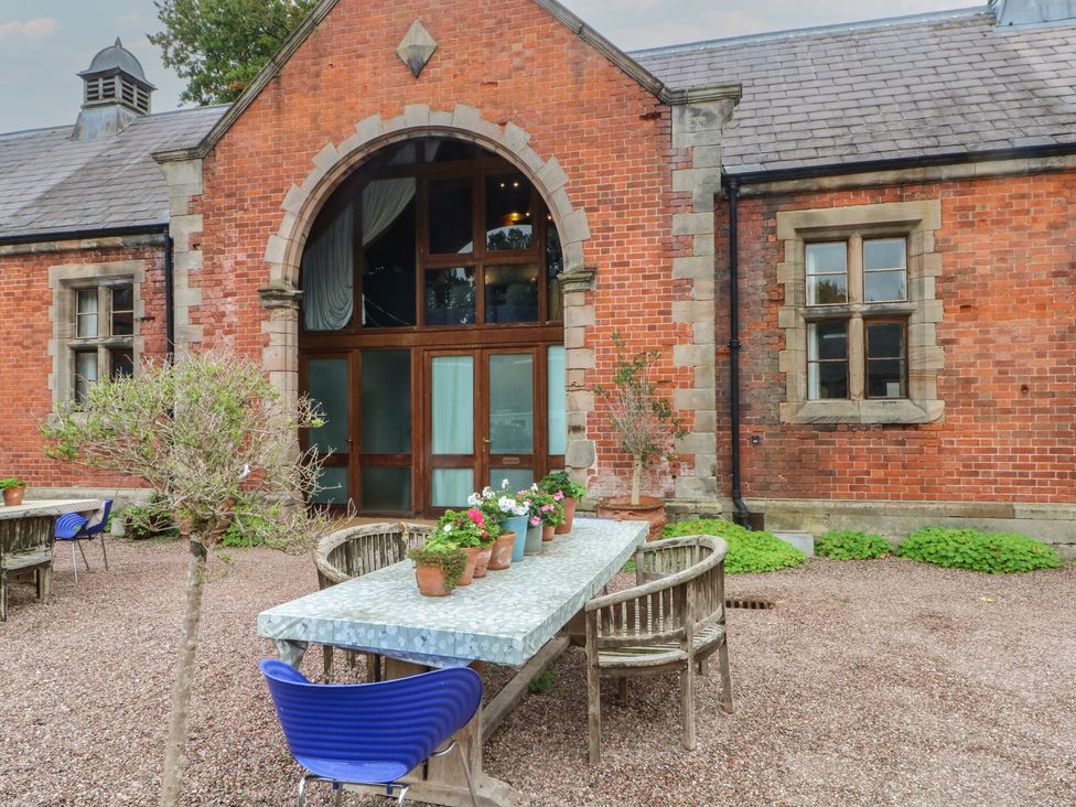 An outdoor area with a table and chairs at Diamond Lodge Ingestre near Great Haywood
