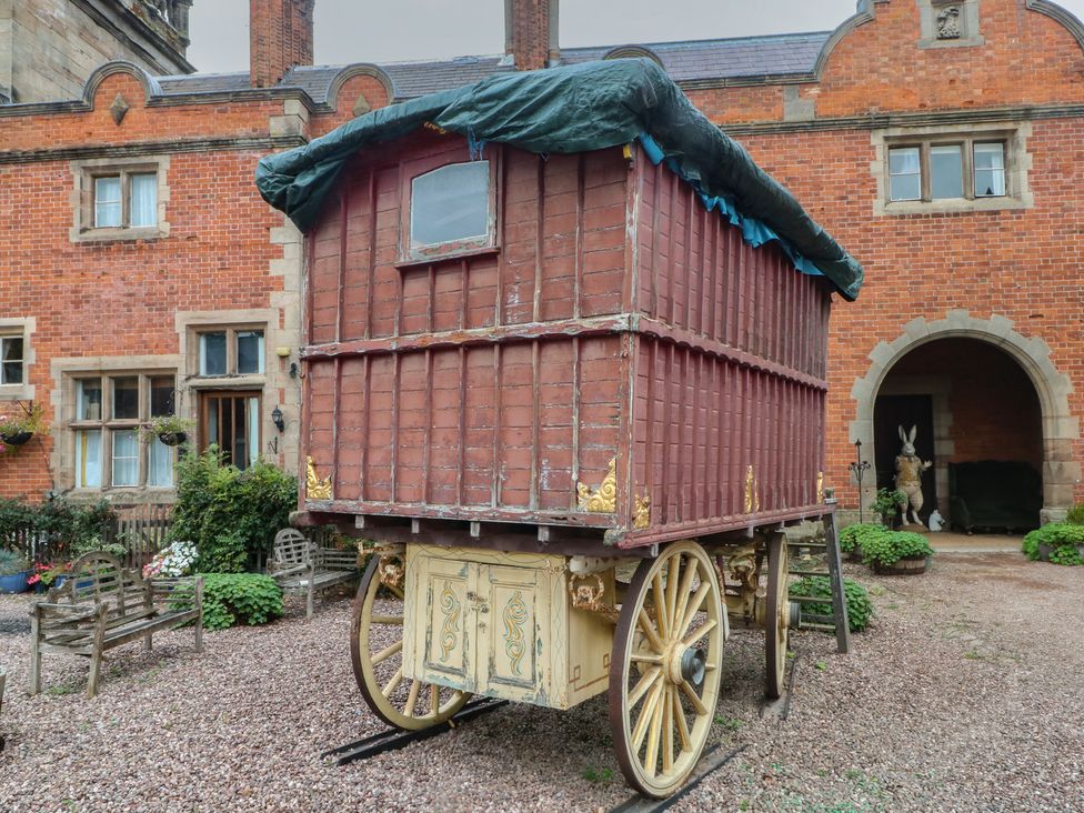 A caravan with wheels covered with a tarpaulin at Diamond Lodge in Ingestre near Great Haywood