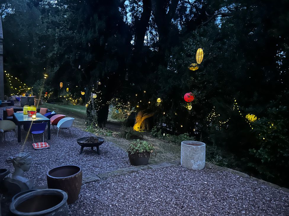 An outdoor garden with seating area and decorative lights at Diamond Lodge Ingestre near Great Haywood