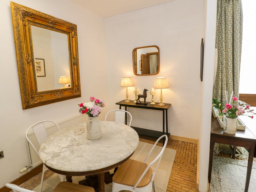 A dining room with a round table and chairs at Diamond Lodge in Ingestre near Great Haywood