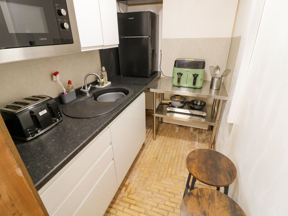 A kitchen with a sink and kitchen appliances at Diamond Lodge in Ingestre near Great Haywood