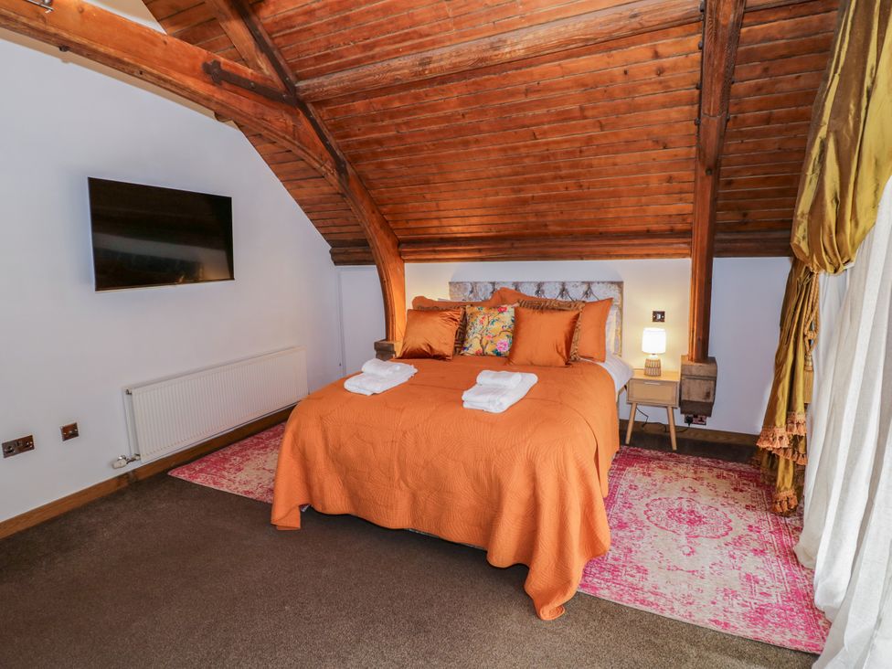 A bedroom with a bed and television at Diamond Lodge Ingestre near Great Haywood