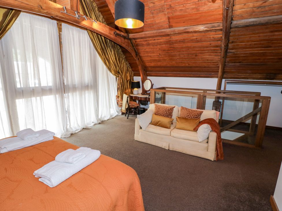 A bedroom with a bed and sofa at Diamond Lodge Ingestre near Great Haywood