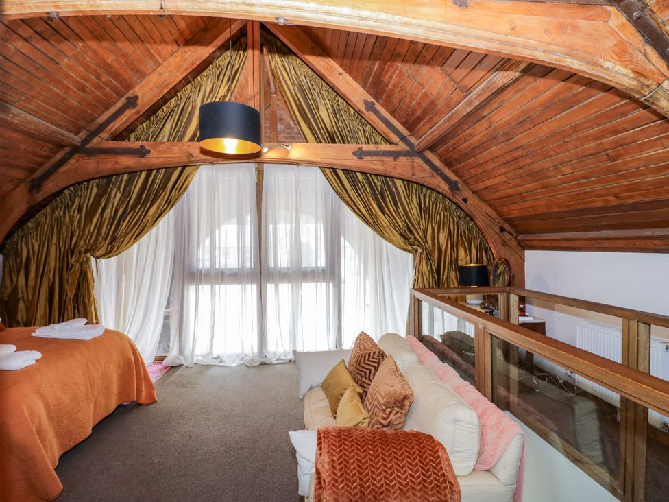 A bedroom with a bed and sofa at Diamond Lodge Ingestre near Great Haywood