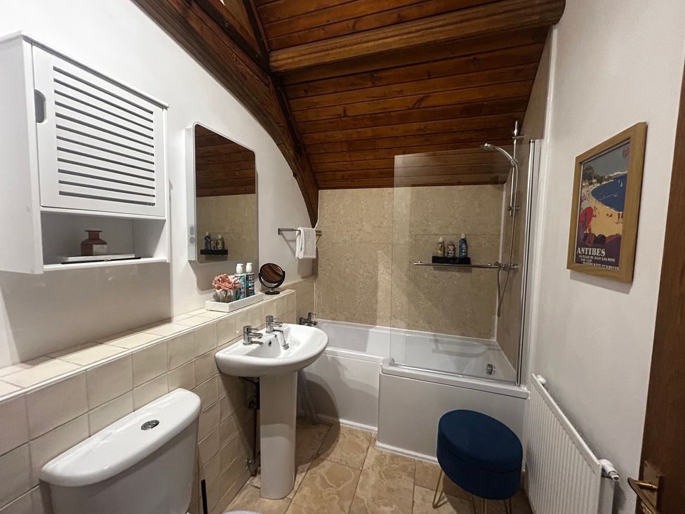 A bathroom with a bathtub and sink at Diamond Lodge Ingestre near Great Haywood