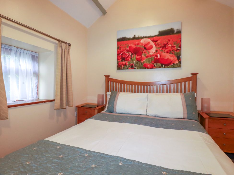 A bedroom with a bed and a window at Cosy Cottage in Dobwalls