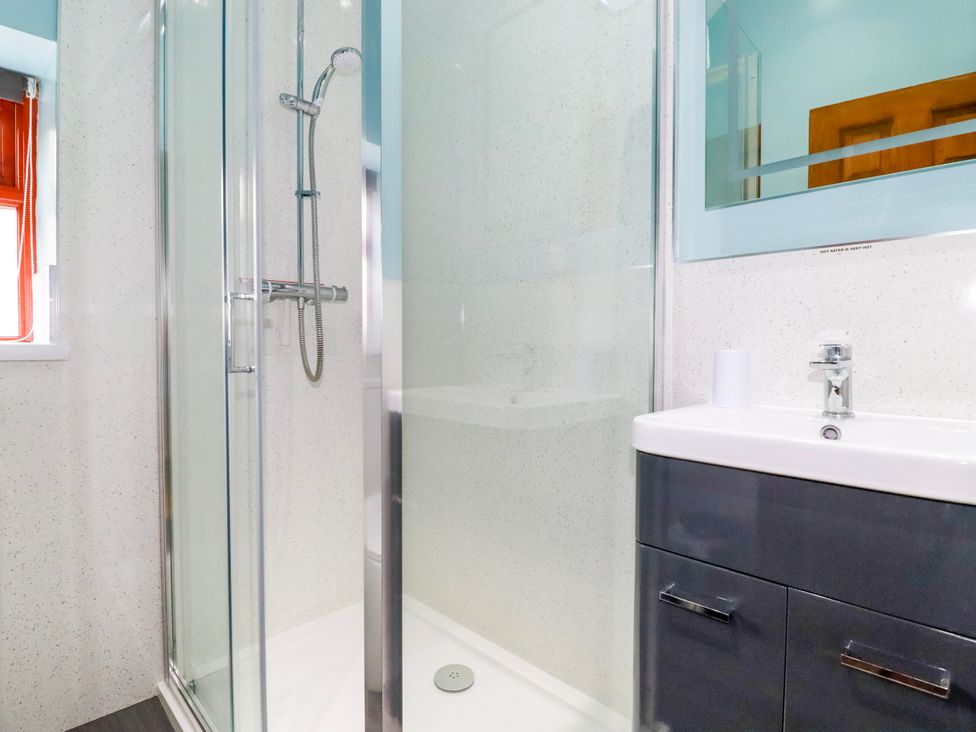 A bathroom with a shower and sink at Cosy Cottage in Dobwalls