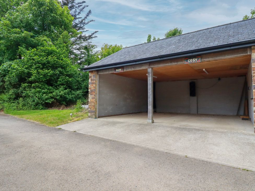 A garage with two openings labeled Barn and Cosy at Cosy Cottage in Dobwalls
