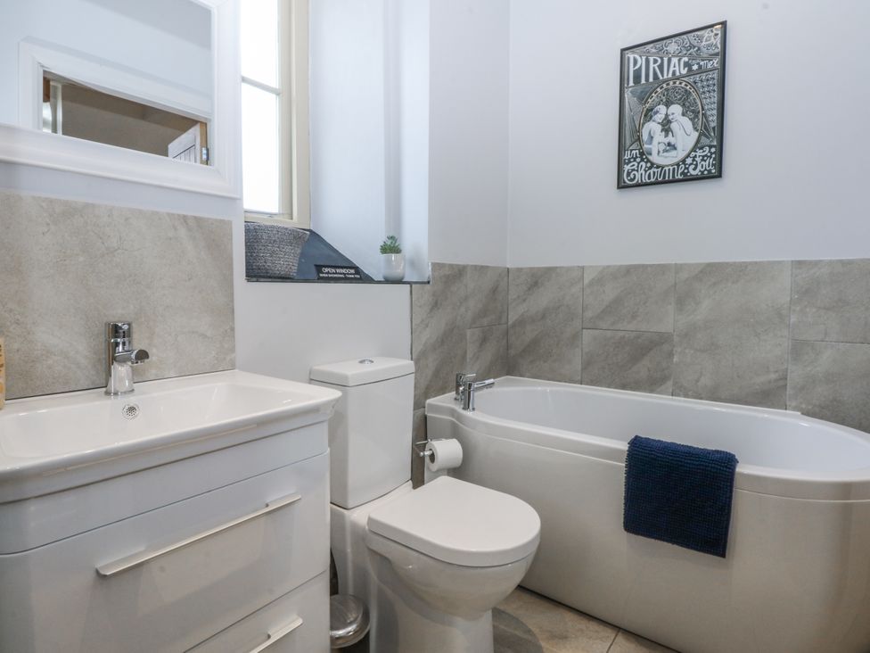 A bathroom with a sink toilet and bathtub at Eglwys St Cynfil Penrhos near Pwllheli
