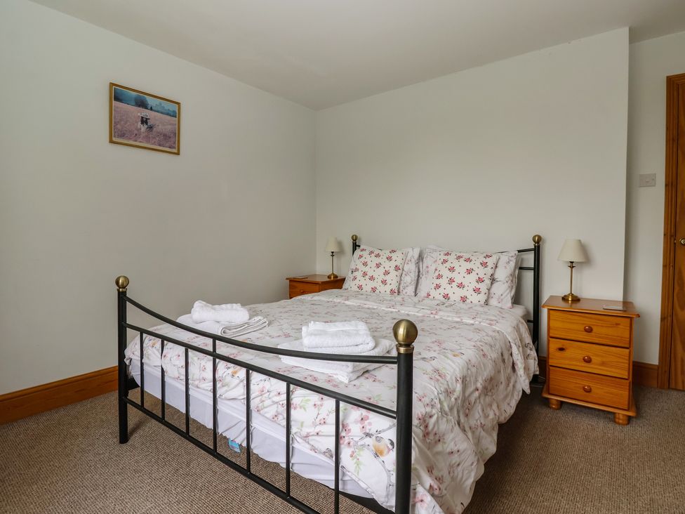 A bedroom with a bed and nightstand at Lillieput Lodge in Melbourne