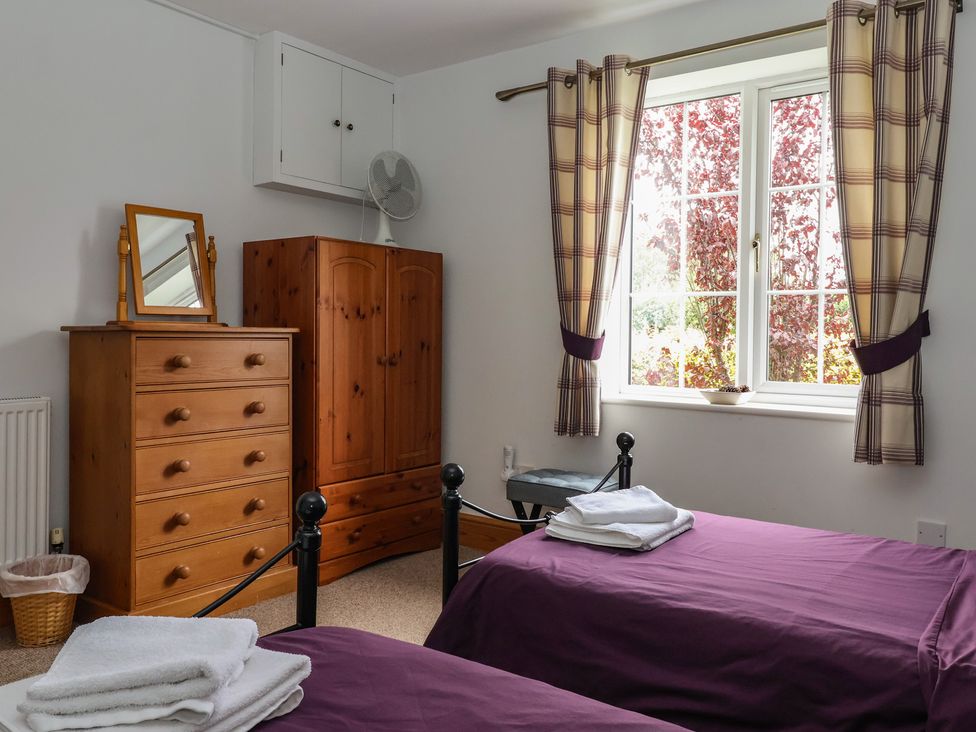 A bedroom with two beds and a wardrobe at Lillieput Lodge Melbourne