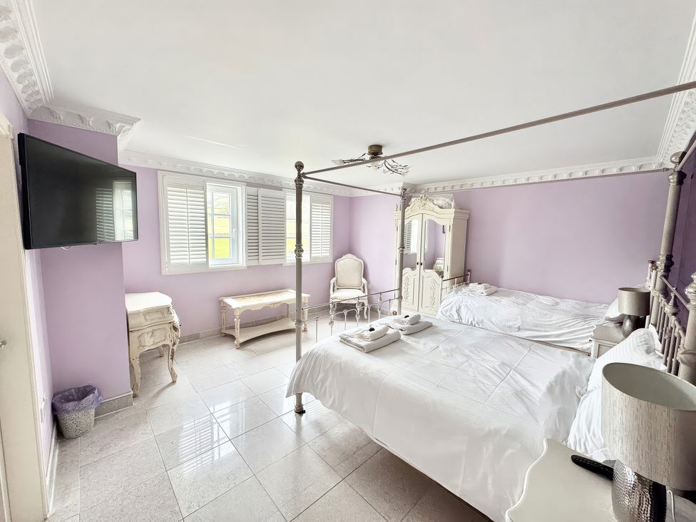 A bedroom with a bed and television at Hartcliffe View in Millhouse Green