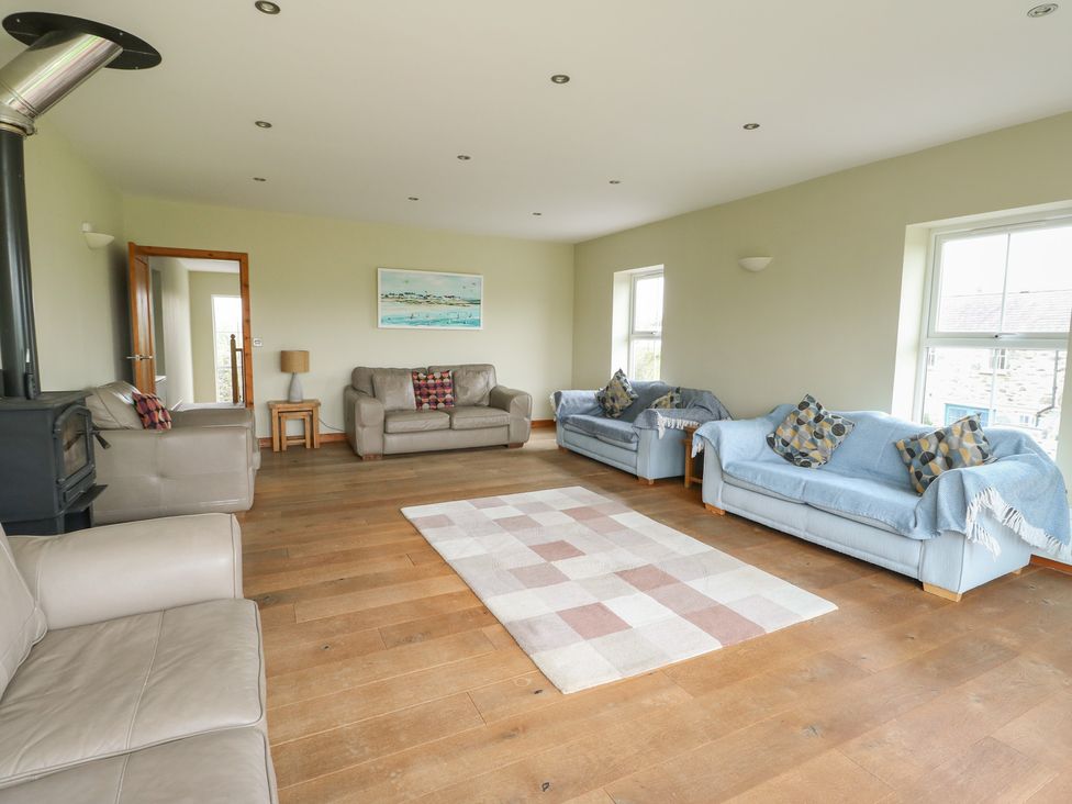A living room with sofas and a lamp at Chapel House Elim near Llanddeusant
