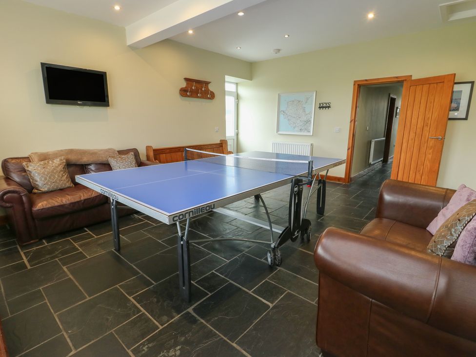 A game room with a table tennis table in Chapel House Elim near Llanddeusant