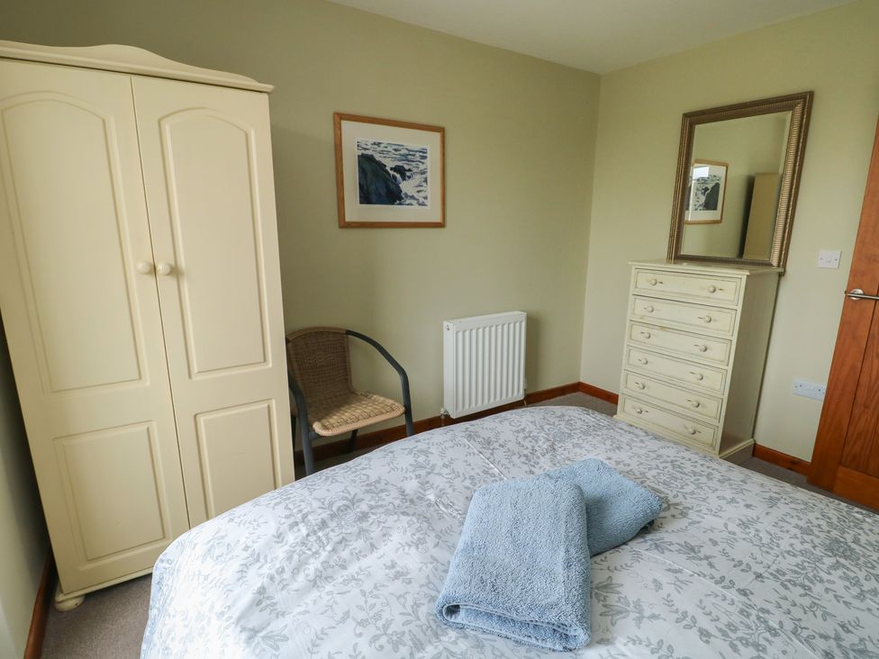 A bedroom with a bed and wardrobe at Chapel House Elim near Llanddeusant