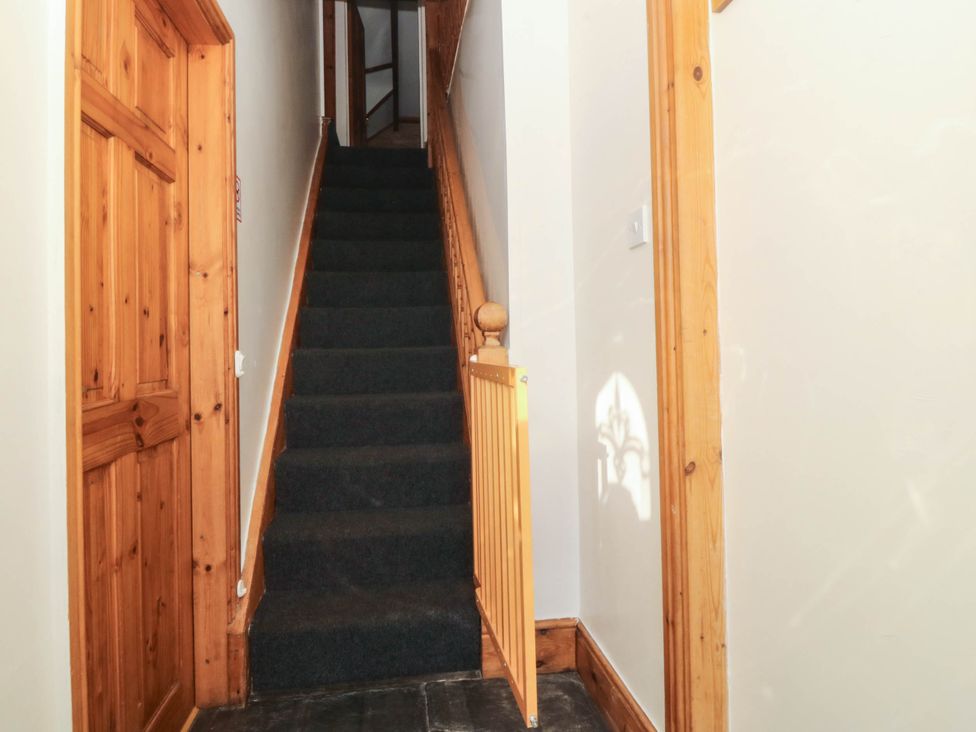A hallway with stairs leading to an upper level at Tyddyn in Dyffryn Ardudwy