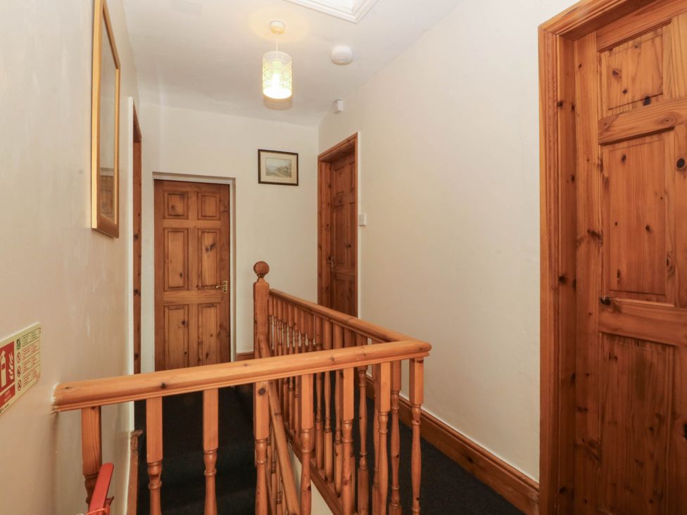 A hallway with doors and a staircase at Tyddyn in Dyffryn Ardudwy