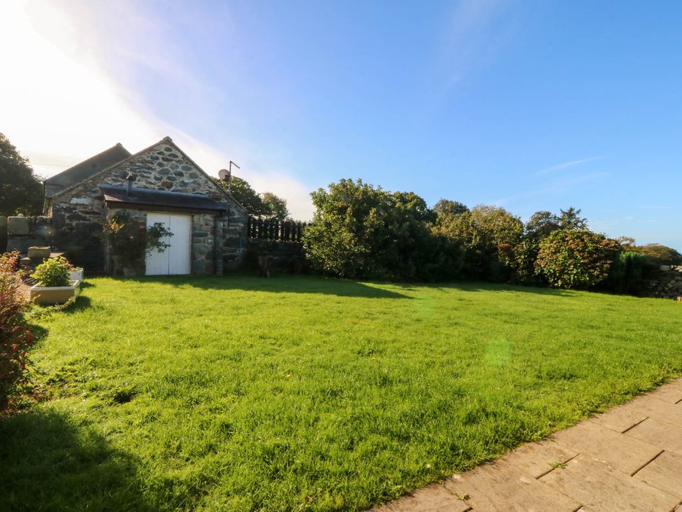 An outdoor area with a stone building and grass at Tyddyn in Dyffryn Ardudwy