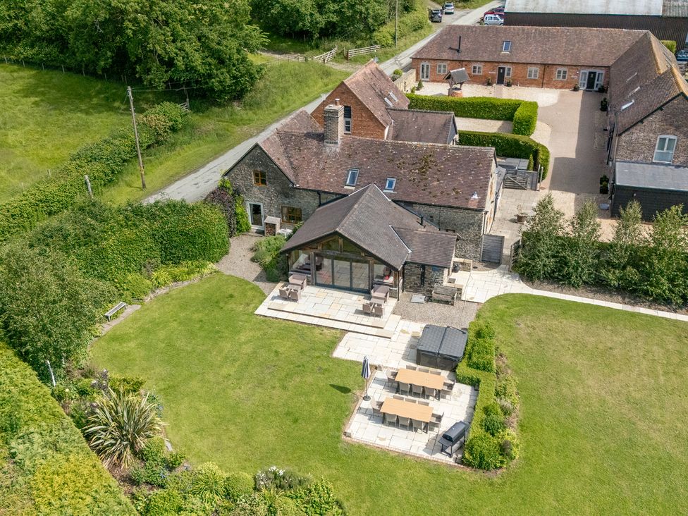 A garden with a patio and seating area at The Wain House in Westhope near Church Stretton
