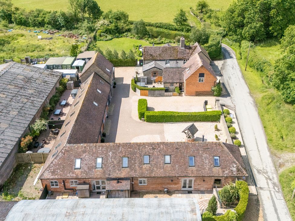An aerial view of multiple houses and a gravel driveway at The Wain House Westhope near Church Stretton