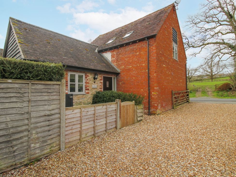A house with a gravel driveway and grass area at The Wain House in Westhope near Church Stretton