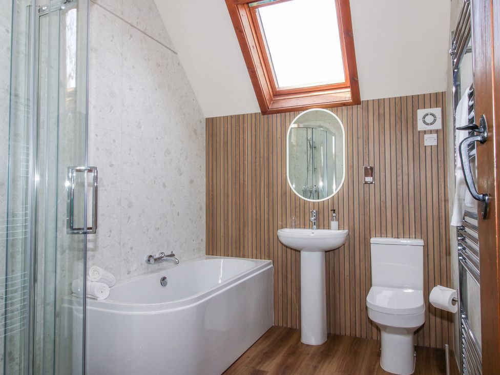 A bathroom with a shower, bathtub, sink, and toilet at The Wain House in Westhope near Church Stretton