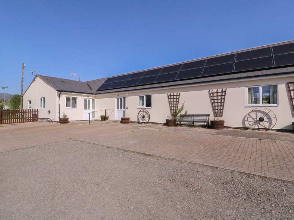 An outdoor view of a building with solar panels at The Turbles - Swallows Nest in Castlemorton near Welland