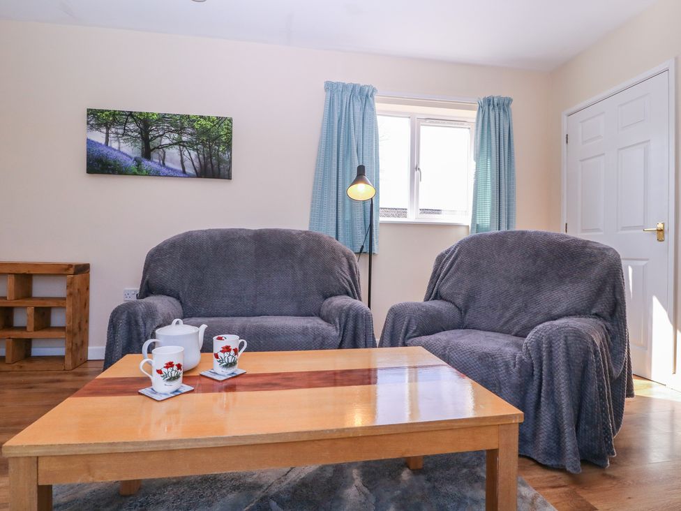 A living room with a table and two sofas at The Turbles - Swallows Nest Castlemorton near Welland