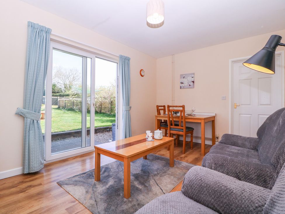 A living room with a sofa and coffee table at The Turbles - Swallows Nest in Castlemorton near Welland