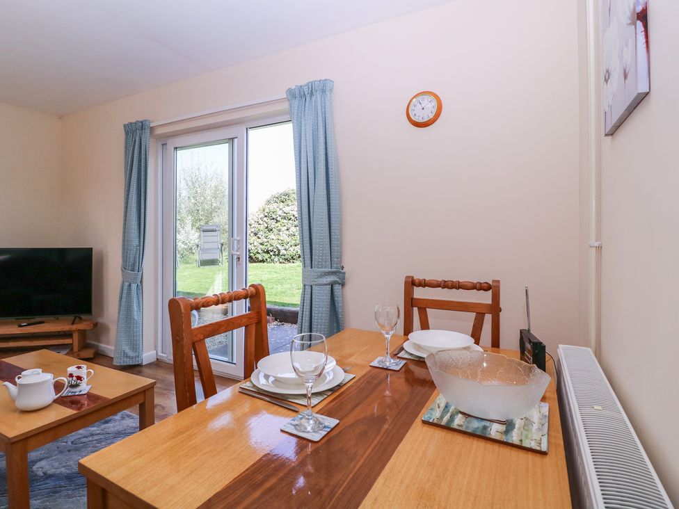A dining room with a table set for two at The Turbles - Swallows Nest in Castlemorton near Welland
